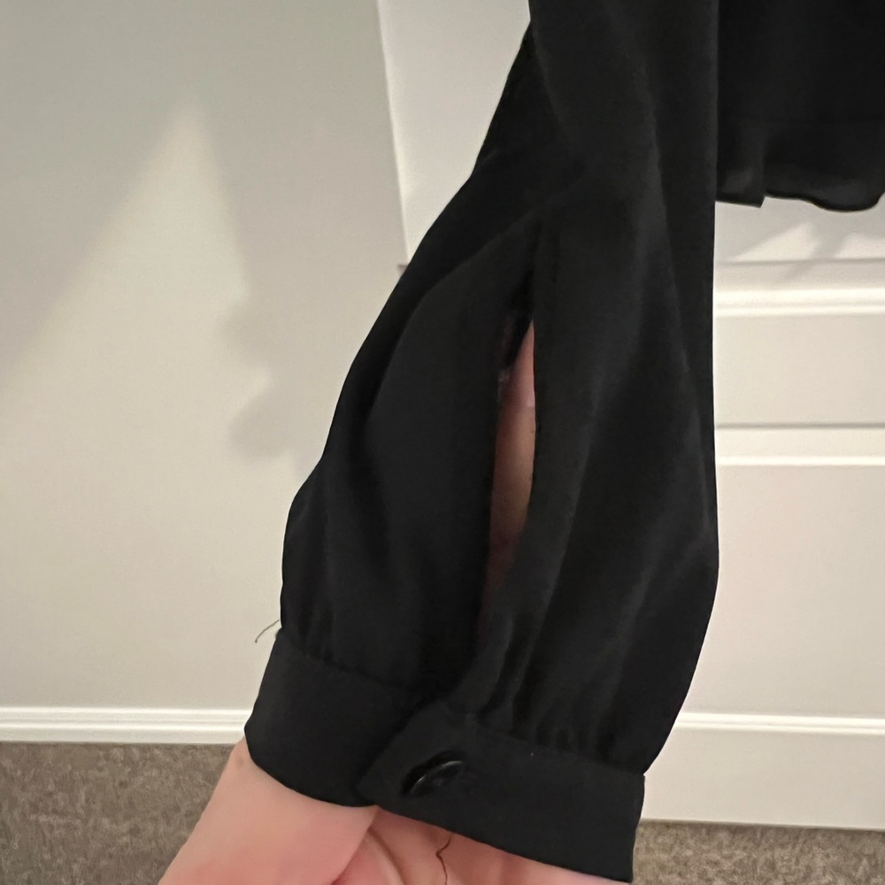 Zara size XS w/lace, ruffle trim, and a buttoned up back. Absolutely Gorgeous.